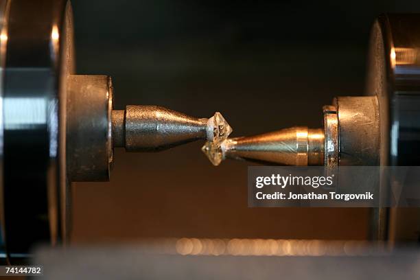 Diamonds are being cut at one of Israel's diamond cutting factories November, 2005 in Ramat-Gan, Israel. Cutting a rough diamond takes great skill. A...