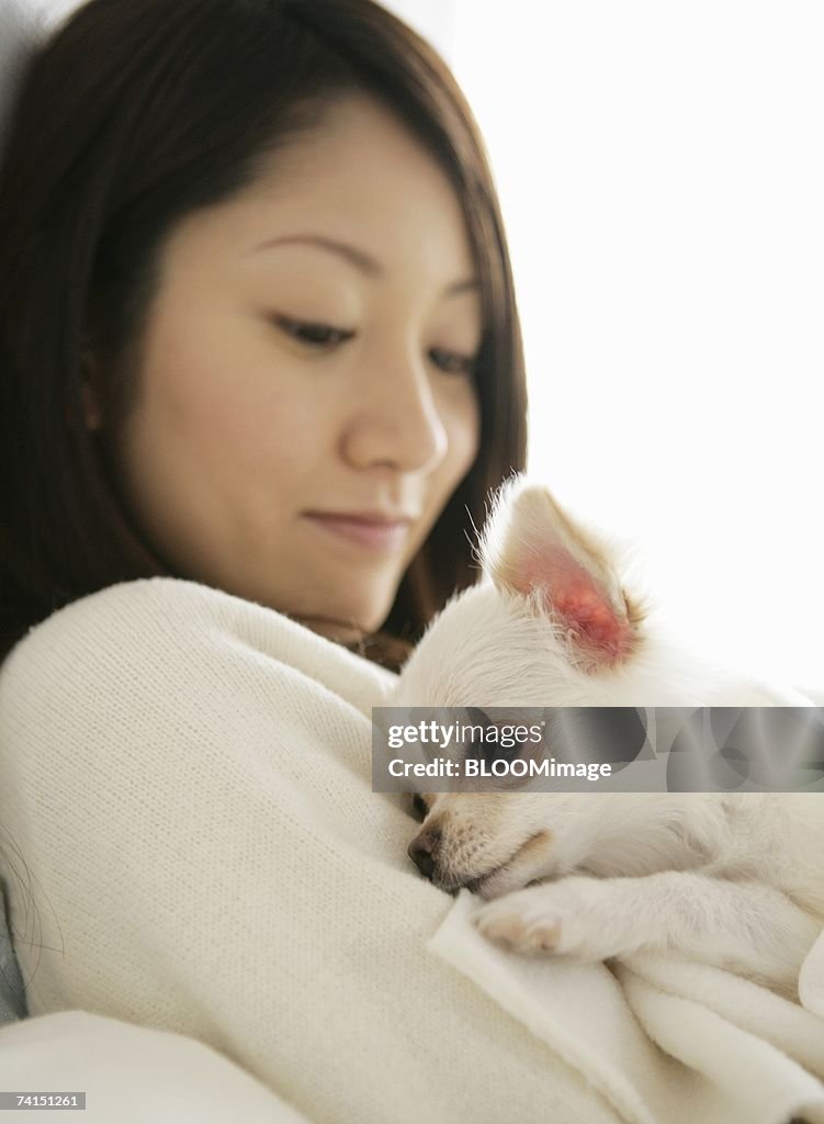 Dog holding  woman's arm