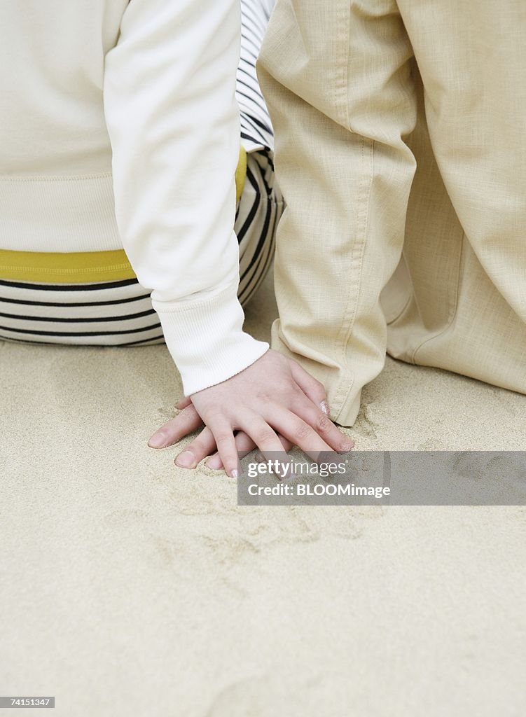 Japanese couple touching hand each other on beach