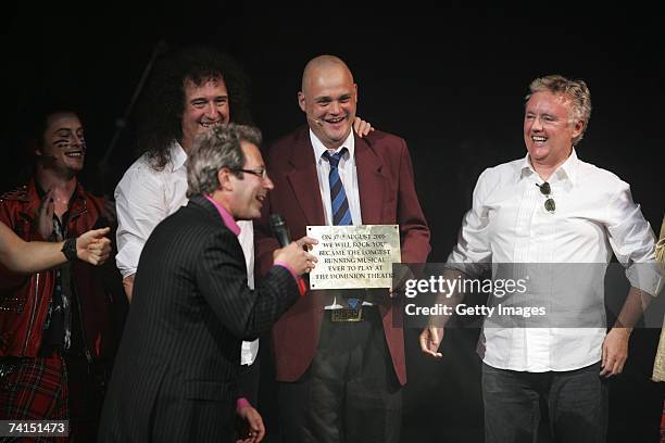 Writer Ben Elton, comedian Al Murray and Queen's Brian May and Roger Taylor appear on stage with a plaque announcing We Will Rock You as longest...