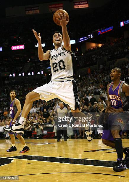 Guard Manu Ginobili of the San Antonio Spurs takes a shot against Leandro Barbosa of the Phoenix Suns in Game Four of the Western Conference...