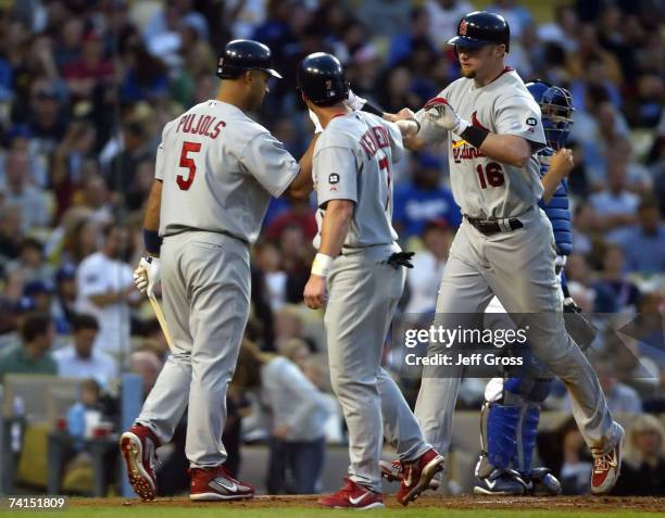 Albert Pujols and Adam Kennedy of the St. Louis Cardinals congratulate teammate Chris Duncan after Duncan's two-run home run in the second inning...