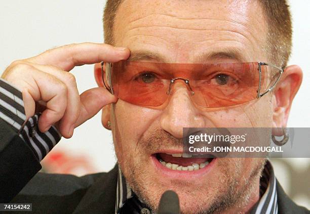 Irish pop band U2 frontman Bono gestures as he addresses a press conference following the release of the DATA report 2007, 15 May 2007 in Berlin....