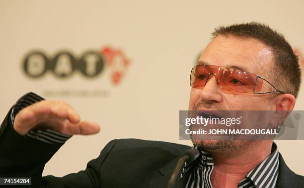 Irish pop band U2 frontman Bono gestures as he addresses a press conference following the release of the DATA report 2007, 15 May 2007 in Berlin....