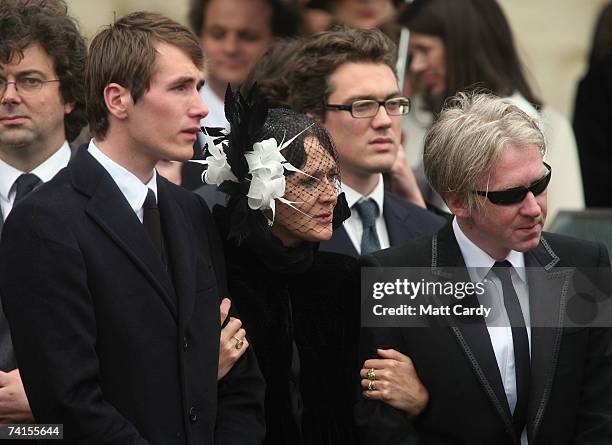 Ottis Ferry and designer Philip Treacy are comforted by Ottis's mother Lucy Ferry at the funeral service for fashion stylist Isabella Blow at...