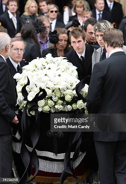 Mourners including Ottis Ferry help as the coffin is lowered at the funeral service for fashion stylist Isabella Blow at Gloucester Cathedral on May...