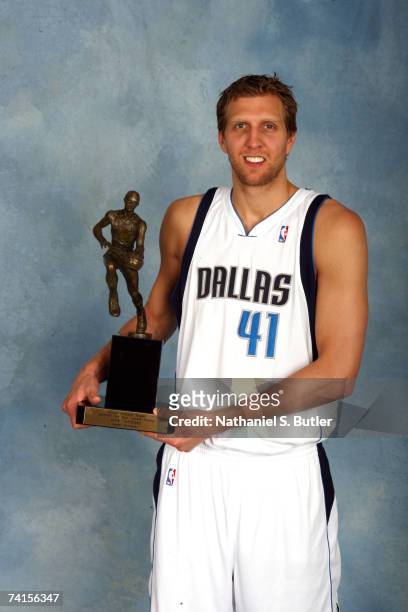 Dirk Nowitzki of the Dallas Mavericks poses for a portrait with the Maurice Podoloff 2006-2007 NBA MVP Trophy during the award presentation on May...