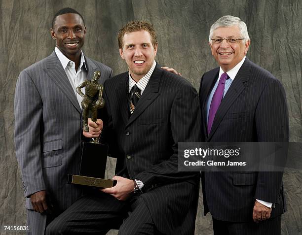 Dirk Nowitzki of the Dallas Mavericks poses with the NBA MVP trophy and Mavs head coach Avery Johnson and NBA Commissioner David Stern at the...