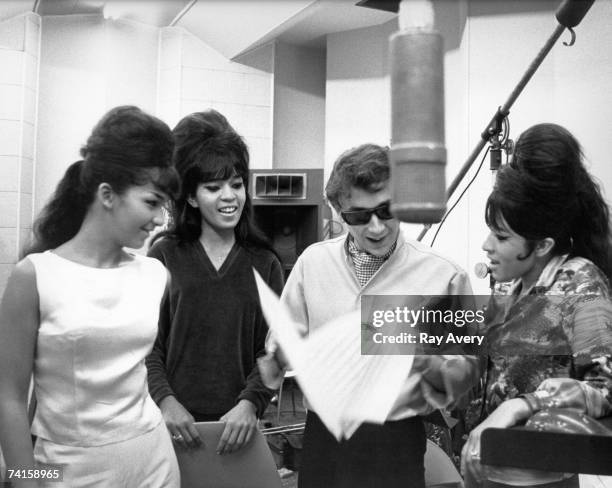 Vocal trio "The Ronettes" with Phil Spector while recording in Los Angeles, California at Gold Star Studios in 1963.