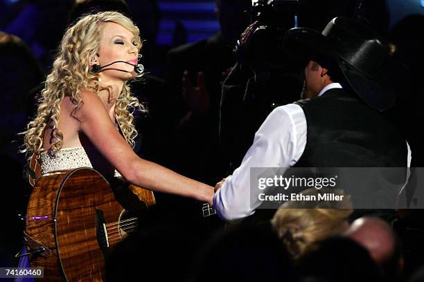 Musician Taylor Swift shakes hands with Tim McGraw during the 42nd Annual Academy Of Country Music Awards held at the MGM Grand Garden Arena on May...