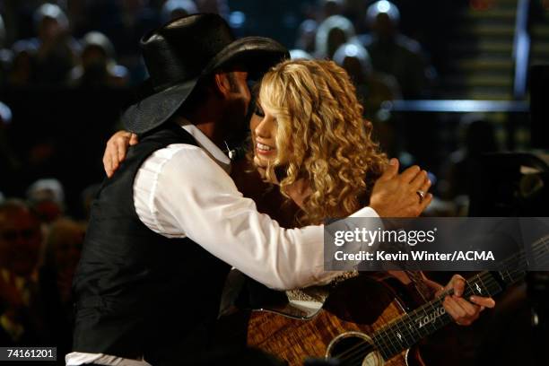 Singer Taylor Swift greets singer Tim McGraw after performing her song titled "Tim McGraw" onstage during the 42nd Annual Academy Of Country Music...