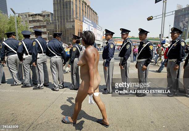 Member of the "400 Pueblos" peasants organization in the nude takes part in a protest 15 May, 2007 in Mexico City. The demonstrators demand that the...
