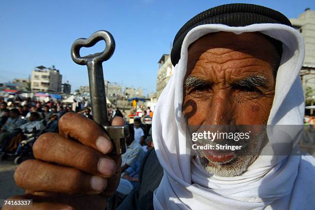 Palestinian refugee Mohamad Mahmoud Al-Arja from the Rafah refugee camp, holds up a key allegedly from his house in Beer AI-saba, now located in...