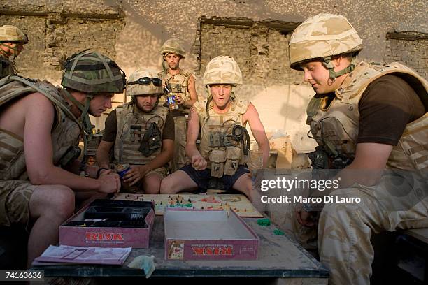 British Soldiers from the Grenadier Guards play Risk in their downtime at the Delhi Patrol Base on May 14, 2007 in Southern Helmand Province,...