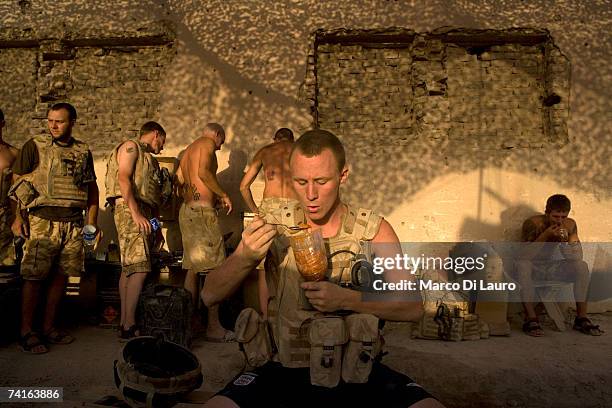 Guardsman Ashley O'Sullivan, a British Soldiers from the Grenadier Guards eats his food cooked by one of them to break the routine of the military...