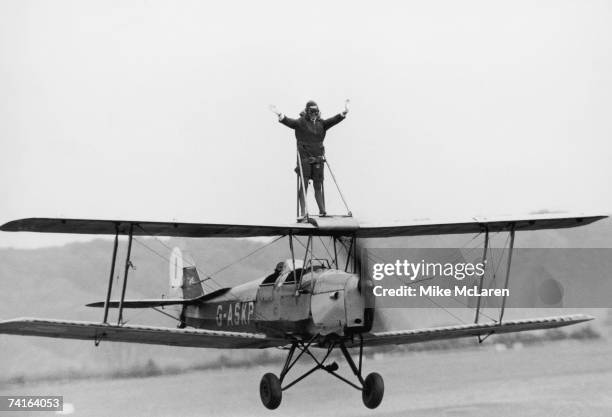 Stewardess Jacqui Cheesman rides the wing of a Tiger Moth at Wycombe Air Park, Buckinghamshire, in preparation for an upcoming flying display at...