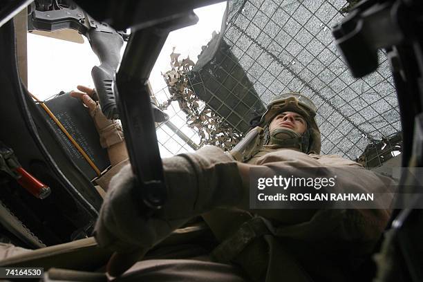 Marine Gunnery LCPL Colston from Kansas city, Missouri, of the 2/6 Battalion, Echo Company, keeps a lookout from the turret of a Humvee vehicle in...