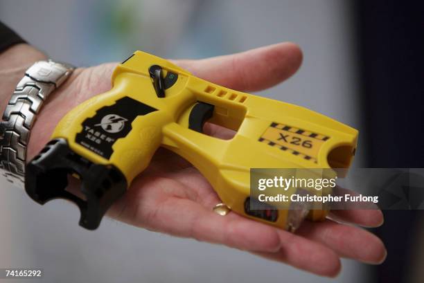 Representative from Taser International shows the companies latest X26 stun gun during the Police Federation Conference at Winter Gardens on May 16,...