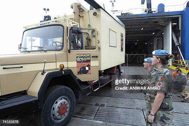 Two French UNIFIL soldiers attend the arrival 16 May 2007 at Beirut port of an all powerful all terrain vehicle with an integrated information and...