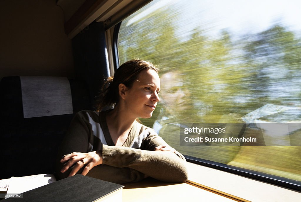 Woman looking out the window from a train.