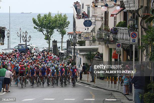 Pack of riders passes the village of Amalfi in the "Costiera Amalfitana" during the fourth stage of the Giro d'Italia cycling race, 153 km leg from...