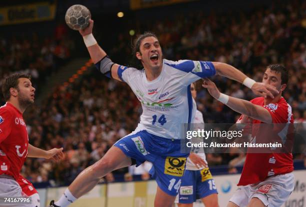 Bertrand Gille of Hamburg in action with Momir Ilic of Gummersbach and his team mate Robert Gunnarsson during the Bundesliga game between HSV...