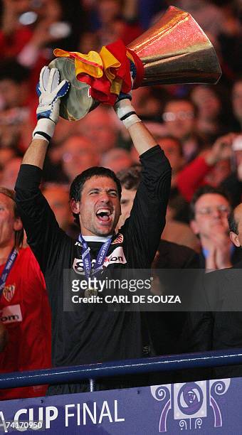 Glasgow, UNITED KINGDOM: Sevilla's Spanish goalkeeper Andres Palop celebrates with the UEFA Cup trophy after beating Espanyol at Hampden Park Stadium...