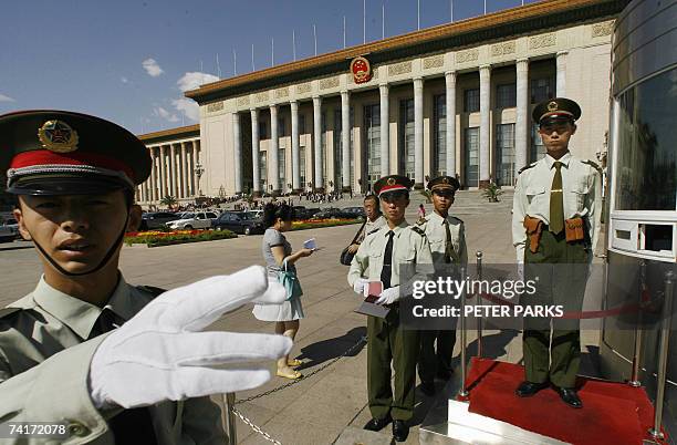 Chinese paramilitary policeman tries to stop photos' being taken outside of the Great Hall of the People in Beijing where the 10th congress of the...