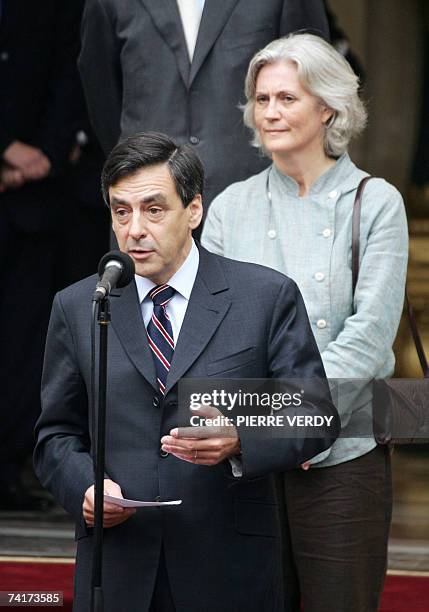 France's new Prime minister Francois Fillon delivers a speech, beside his wife Penelope, during a formal hand over power ceremony with his...