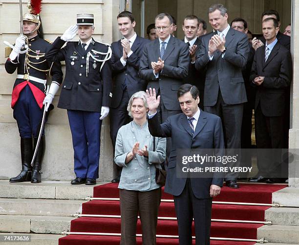 France's new Prime minister Francois Fillon and his wife Penelope salute his predecessor Dominique de Villepin at the end of a formal hand over power...