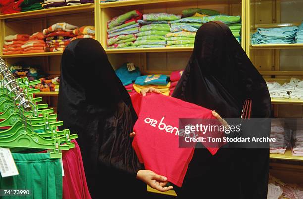 Saudi Arabian women shopping in United Colours of Benetton in Dhahran, wearing the traditional Muslim burqa, December 1990.