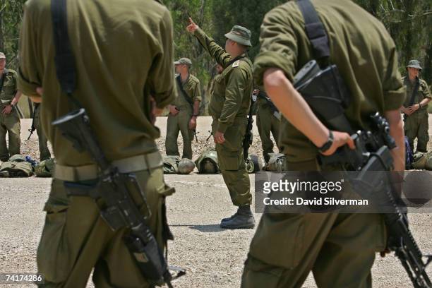 An Israeli army artillery officer briefs his troops after their unit was deployed close to the Israeli-Gaza border as Israel beefs up its forces...