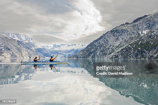 "man and woman kayaking, side view" - glacier bay national park stock-fotos und bilder