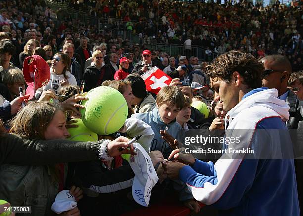 Roger Federer of Switzerland signs autographs for fans after his victory against Juan Carlos Ferrero of Spain during day four of the Tennis Masters...