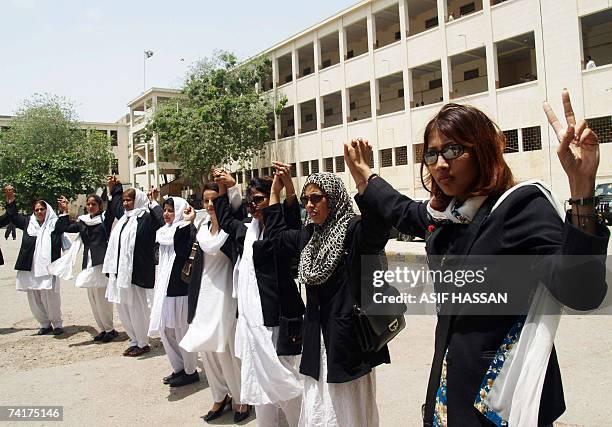 Pakistani women lawyers join hands in front of the City court building during the lawyers' strike in Karachi, 17 May 2007. Pakistani lawyers...