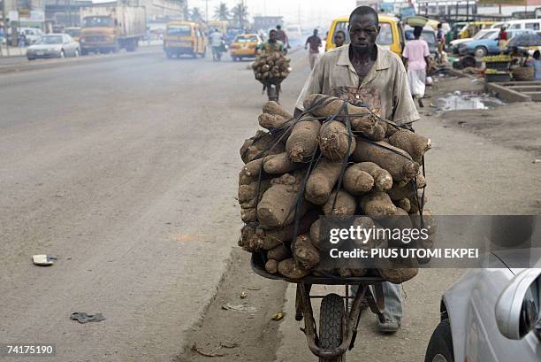 Street vendor hawks tubers of yam in a wheel-barrow in Ketu district of Lagos in defiance of the sit at home ordered by the civil society Thursday 17...