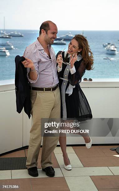 British actress Kelly Brook laughs with her companion US actor Billy Zane during a photocall for Nigerian director David Alki's film 'Fishtales' on...