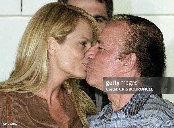Chilean former Miss Universe and present TV host Cecilia Bolocco kisses her husband and former Argentinian President Carlos Menem, 23 November 2001...