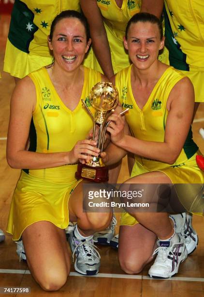 Liz Ellis and Sharelle McMahon of Australia hold the Tri Nations trophy beside their teammates after winning the International England Netball Test...