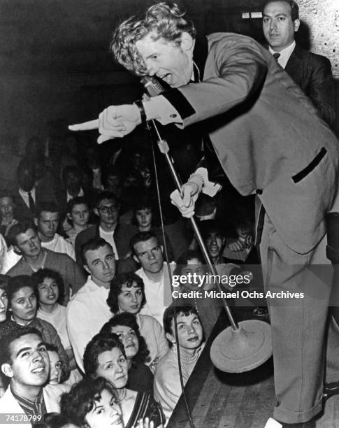 Jerry Lee Lewis performs in concert circa 1957 as disk jocky Art Laboe looks on, in Los Angeles, California.