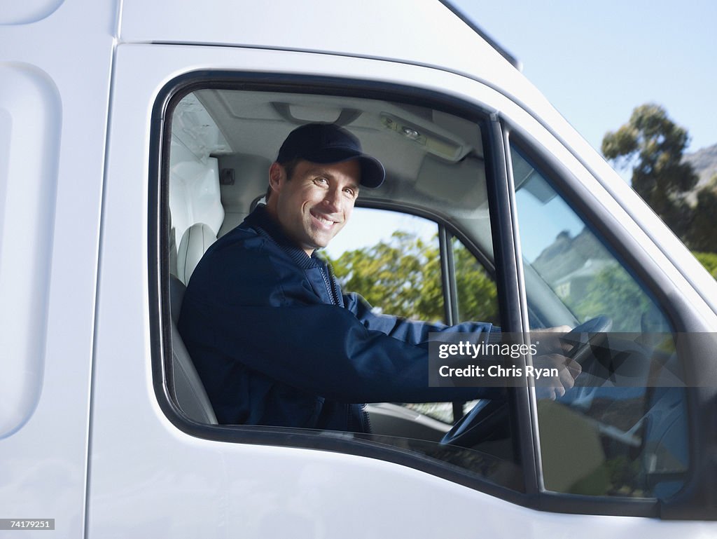 Delivery person driving van