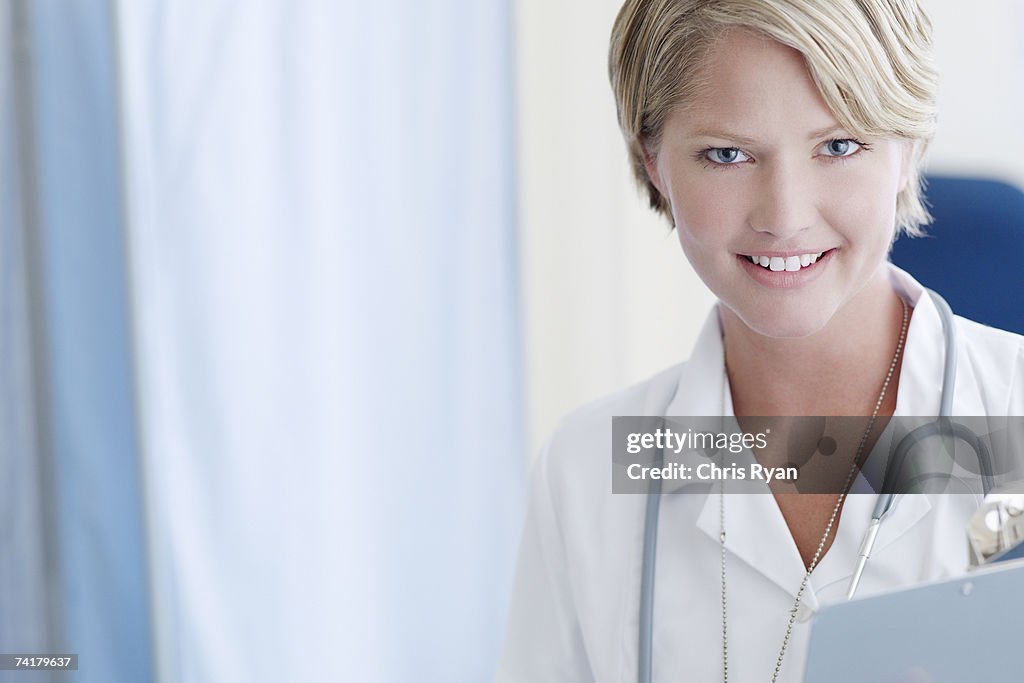 Nurse with clipboard in hospital