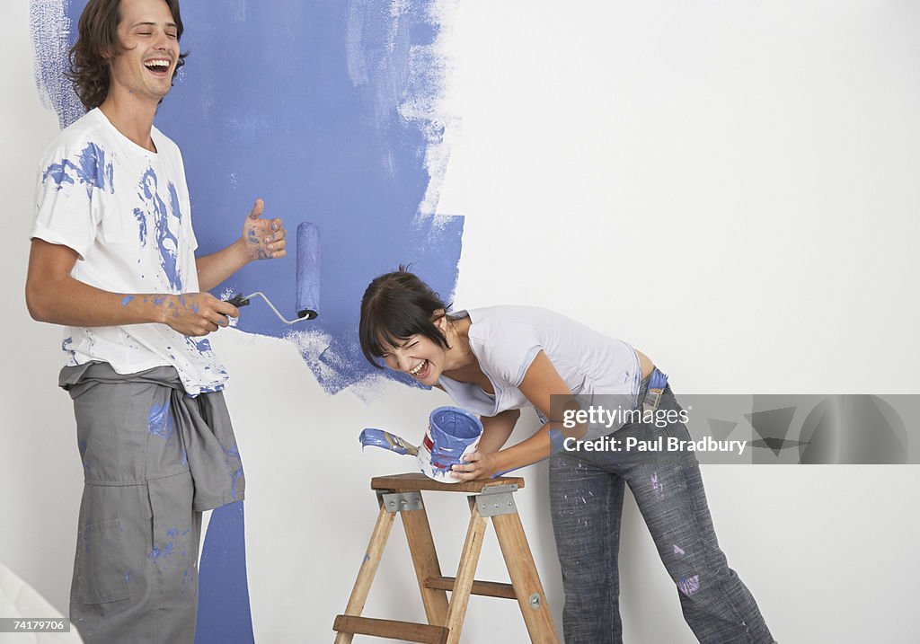 Man and woman playing with paint