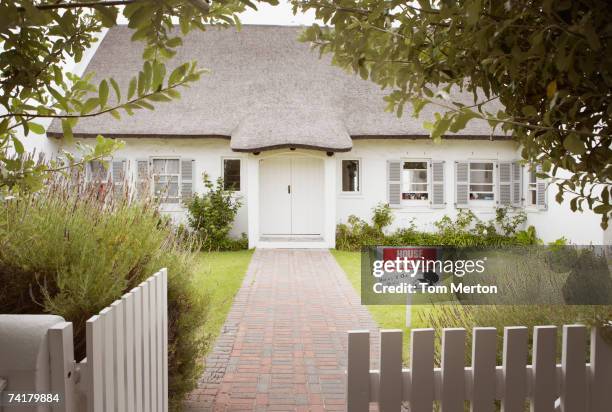 house with for sale sign in yard and open wooden fence - property for sale stock pictures, royalty-free photos & images