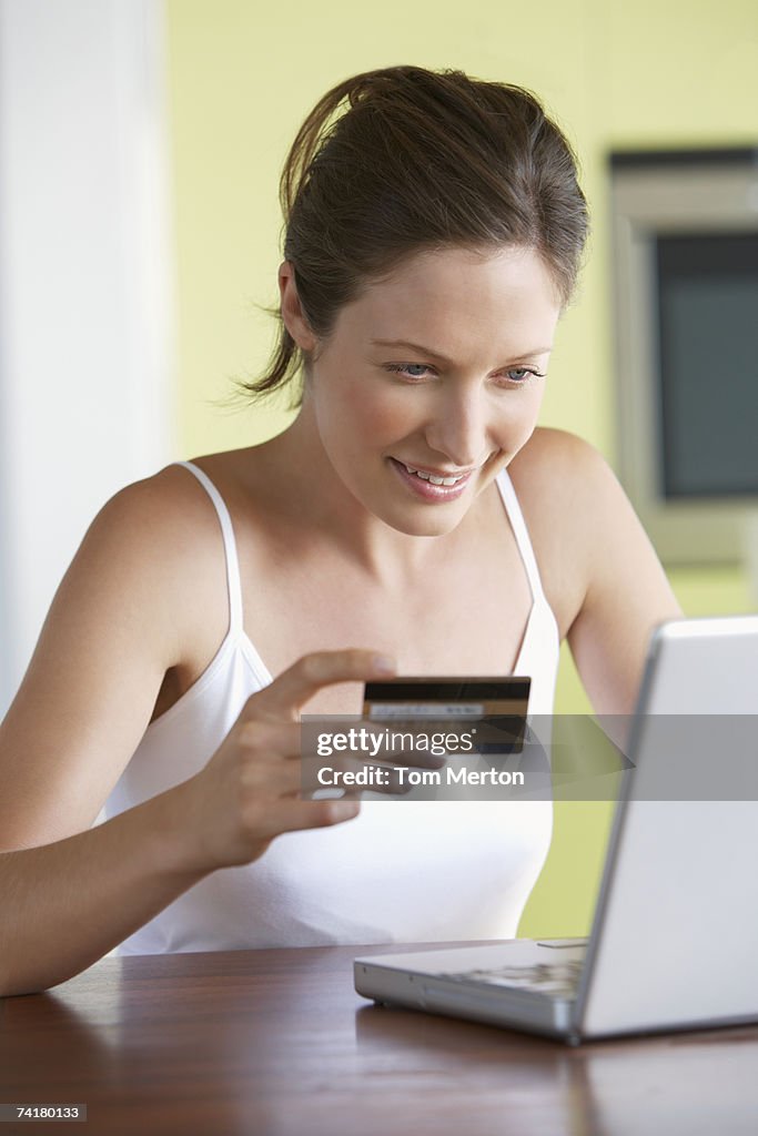 Woman with credit card at laptop