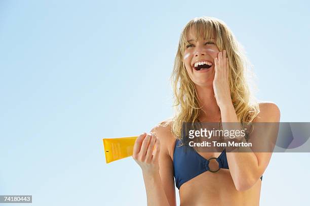 woman in bikini with sun block - suntan lotion stock pictures, royalty-free photos & images