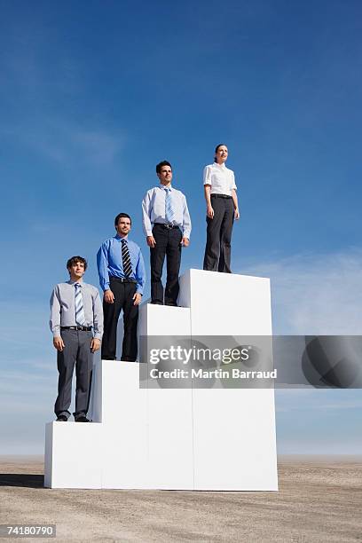 four businesspeople standing on steps outdoors - fou stock pictures, royalty-free photos & images