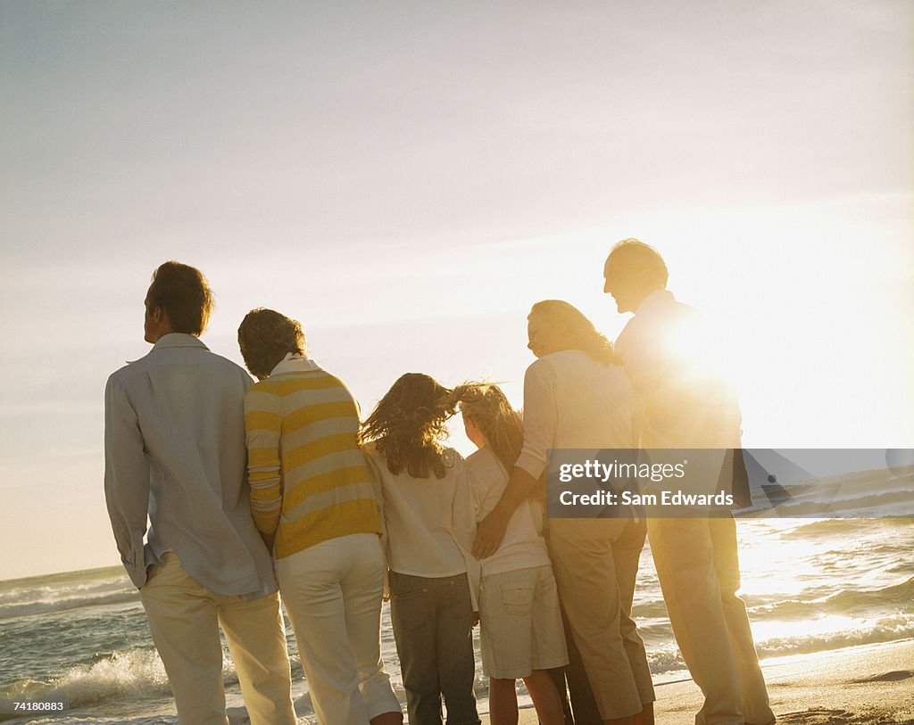 Multigenerational family portrait outdoors at sunset