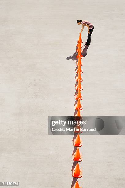 woman lining up traffic cones - rule stock pictures, royalty-free photos & images