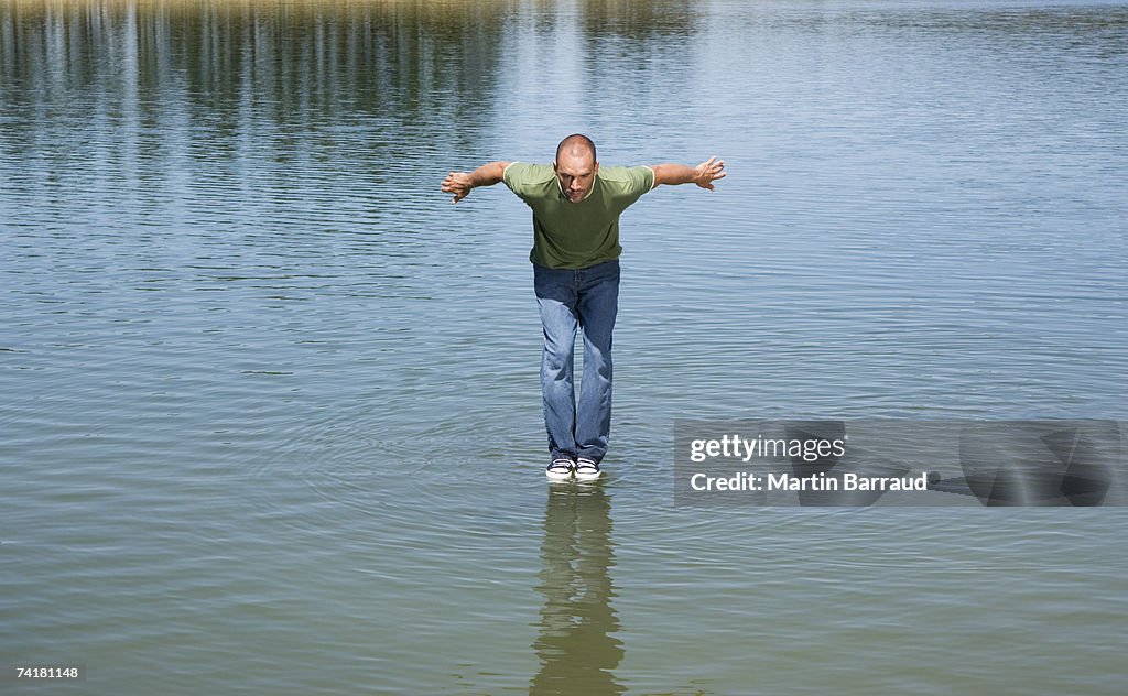 Man standing on water about to jump